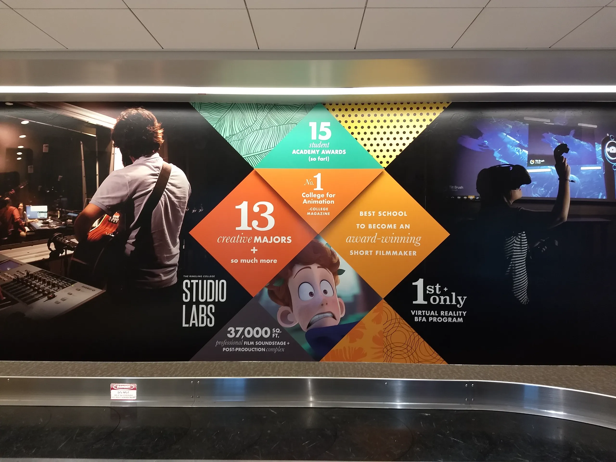 Wall mural features film and animation stats, students using studio equipment, and graphics highlighting awards, creative majors, and virtual reality programs at a college.