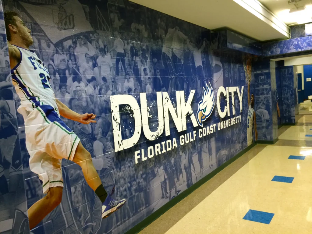 Hallway mural at Florida Gulf Coast University reads “Dunk City” with an image of a basketball player and crowd in the background.