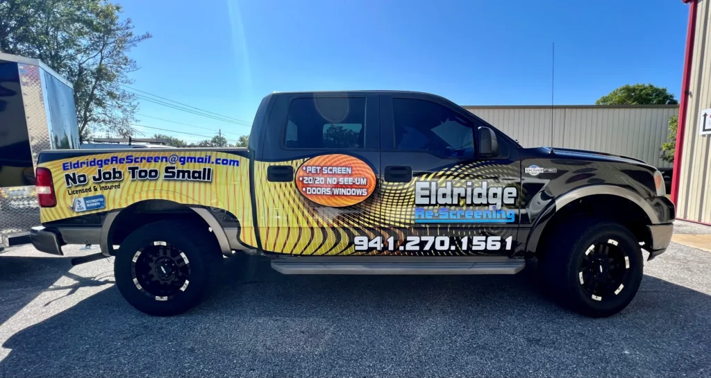 Pickup truck with advertising for Eldridge Re-Screening, including contact info and service details, parked on asphalt under a clear sky.