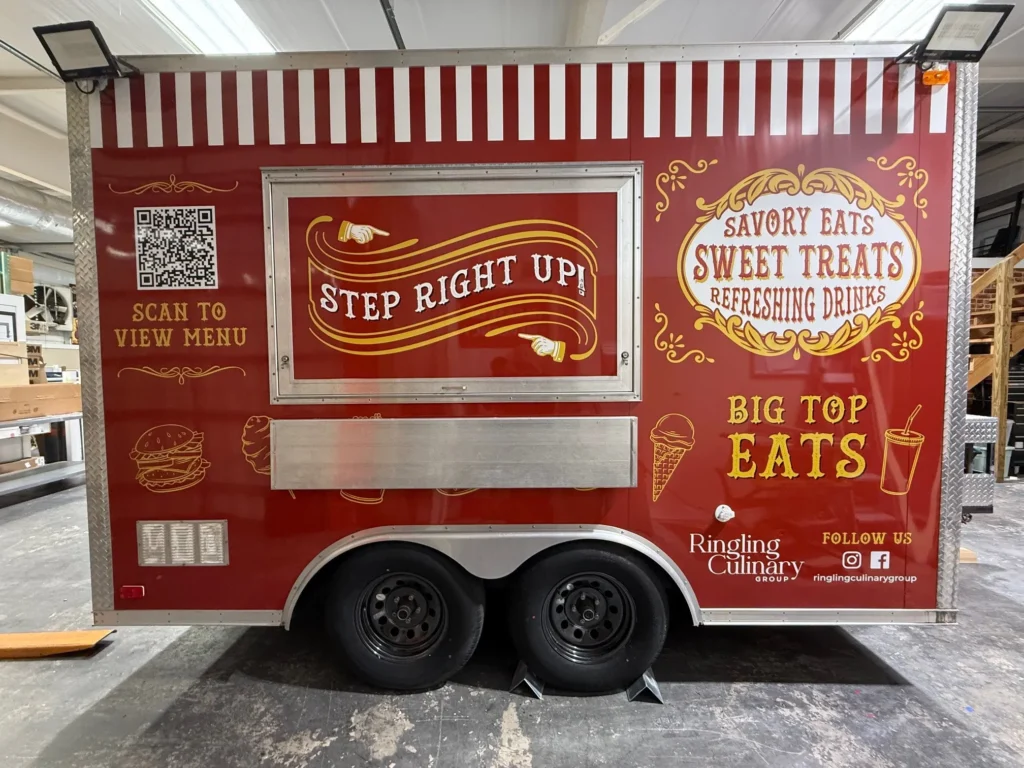 Red food truck with circus-themed graphics, promoting savory eats, sweet treats, and drinks. Includes QR code to view menu, social media icons, and Ringling Culinary branding.